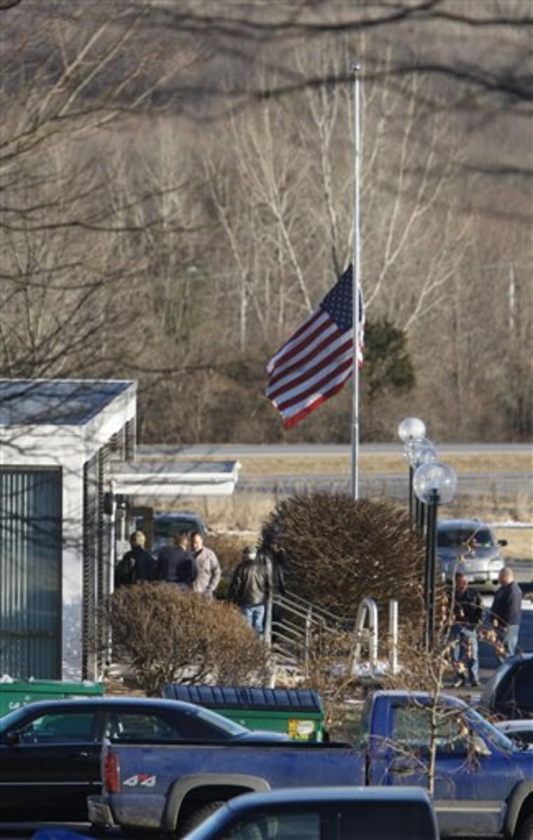 A flag flies at half-staff on Monday at a Plumbers and Pipefitters union training center, where members meet to discuss the explosion at the Kleen Energy Systems power plant.